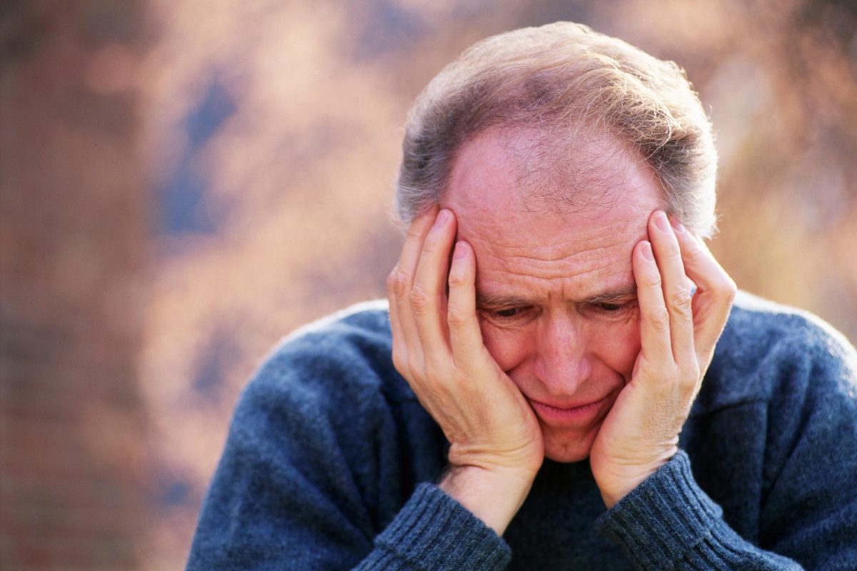 A man with his hands on his head.